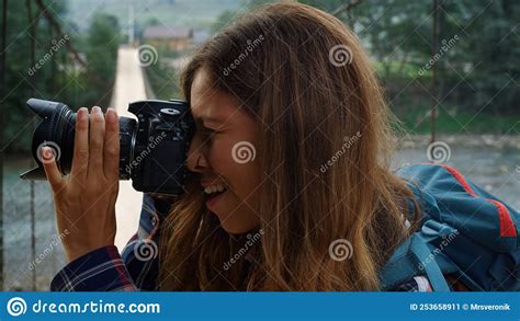 Hitchhiker Woman Taking Photos Using Digital Camera On Nature Forest Landscape Stock Image