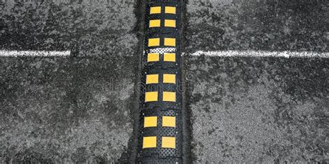 Black Rubber Speed Bump With Yellow Squares On Road Stock Image Image