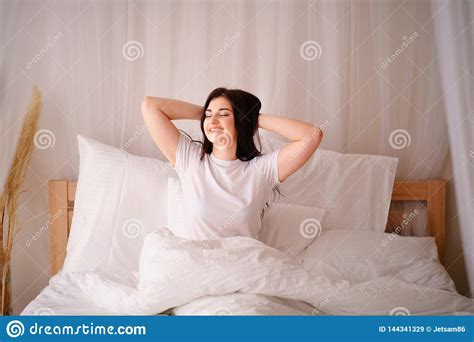 Woman Awakening Stretching In Bed In Early Morning Stock Image Image