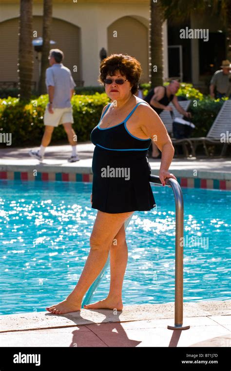 Palm Beach Shores Mature Middle Aged Large Portly Lady In Black Swimming Costume Poses By Pool