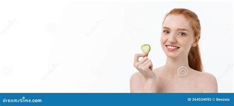 Close Up Beauty Portrait Of A Smiling Beautiful Half Naked Woman Holding Cucumber Slices At Her