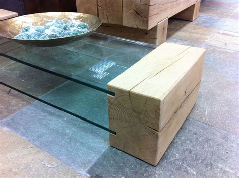 Constellation coffee table, a rectangular glass topped coffee table with angular metal legs in a stainless steel finish and a clear glass top. Coffee table made from new oak railway sleepers and ...
