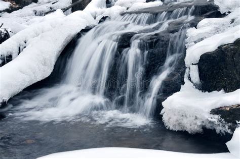 A Small Mountain Waterfall Covered In Snow Stock Photo Image Of