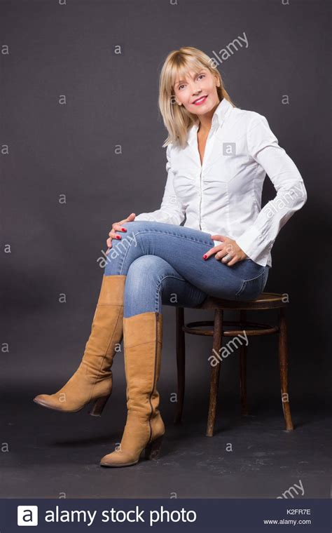 Beautiful Mature Woman 40s Sitting In Chair Studio White