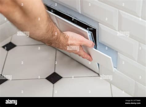 Open Hidden Revision Sanitary Hatch On The Wall Of Tile Under The