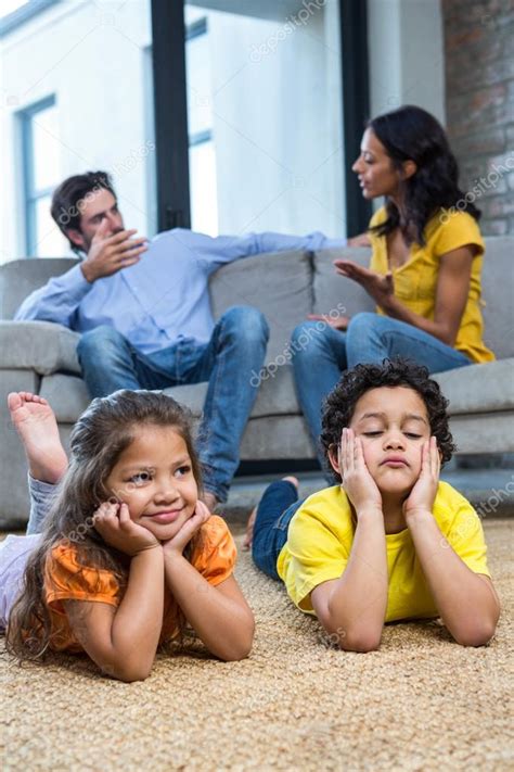 Children Laying On The Carpet In Living Room Stock Photo By