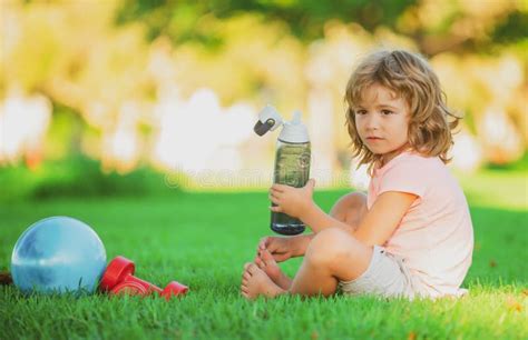 Sport Boy Drinking Water In Park Sporty Kids Concept Stock Photo
