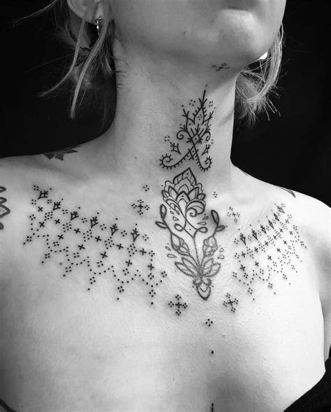 a woman s chest with an intricate design on the top and bottom part of her neck
