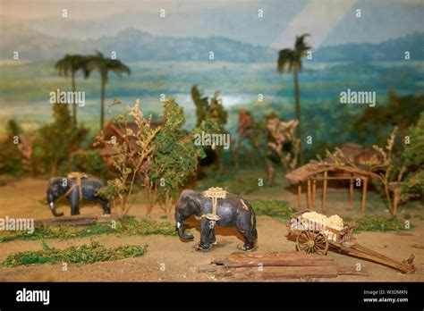 Diorama Depicting Elephants Hauling Logs In A Village At The Arts