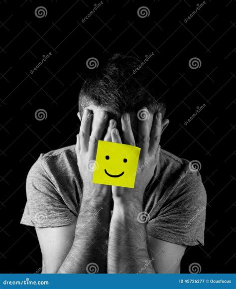 Young Man Suffering Depression And Stress Alone With Smiley Face Post