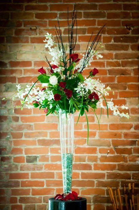 Tall Wispy And Airy Centerpieces Of Red Roses White Delphinium White