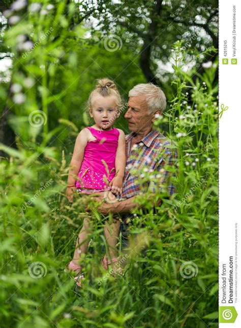 grandfather with his granddaughter stock image image of green happiness 42615245