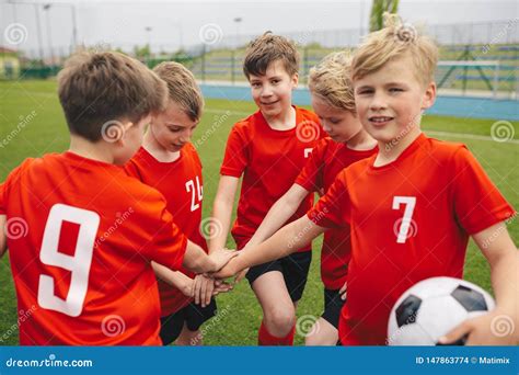 Kids On Football Soccer Team Putting Hands In Boys Football School