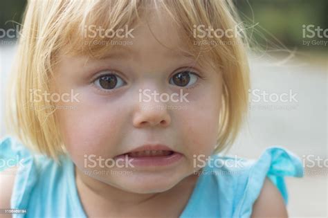 Adorable Little Girl Making Disgusted Or Surprised Face Stock Photo