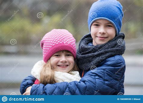 Two Children Boy And Girl Hugging Each Other Outdoors