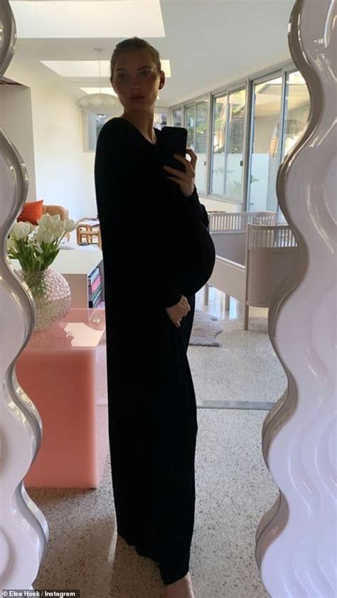 Elsa Hosk Showcases Growing Baby Bump In Clingy Black Dress While