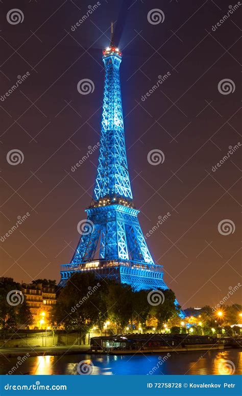 The Eiffel Tower Lit Up In Blue Color At Night Paris France