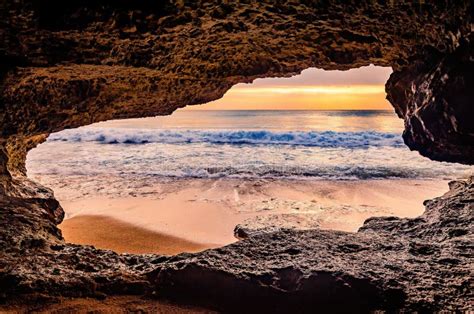Ocean View During Sunset From Inside A Cave Looking Out A Rock Cave To