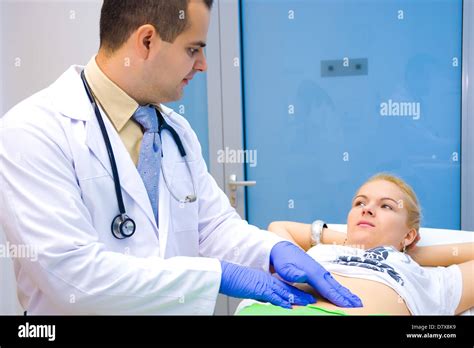 The Doctor Examines The Patients Abdomendoctor And Patient Shoot A