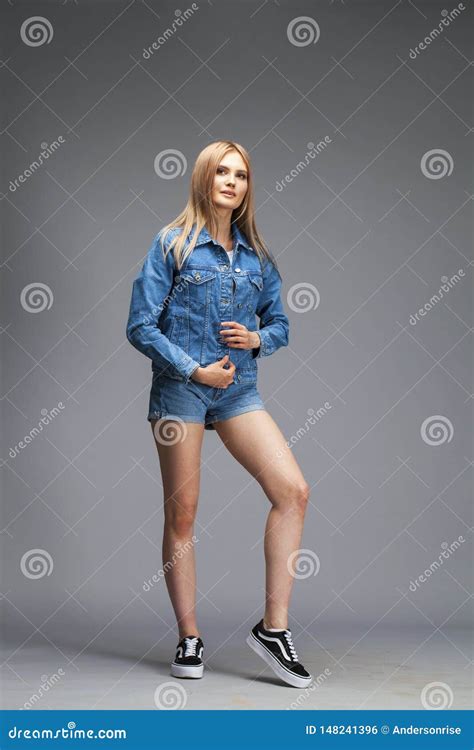 Beautiful Blonde Woman Dressed In A Denim Jacket And Shorts Stock Photo Image Of Happy Female