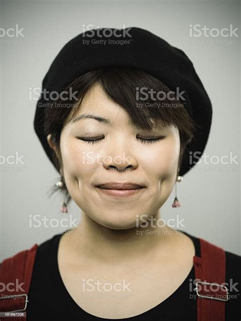 Portrait Of A Happy Young Japanese Woman Looking At Camera Stock Photo
