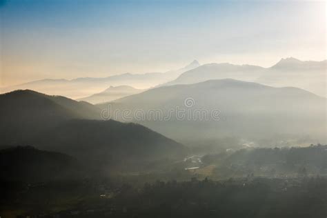 Blue Toned Mountain Silhouette And Foggy Valleys In Winter Stock Image