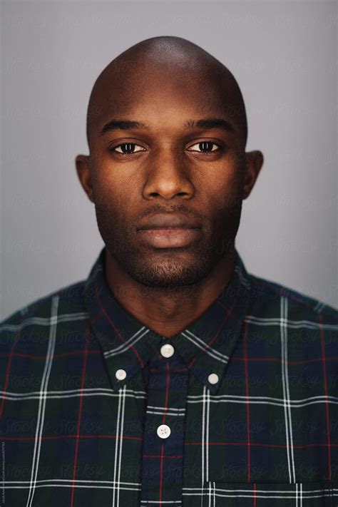 Close Up Of A Black Young Man Looking At Camera By Stocksy