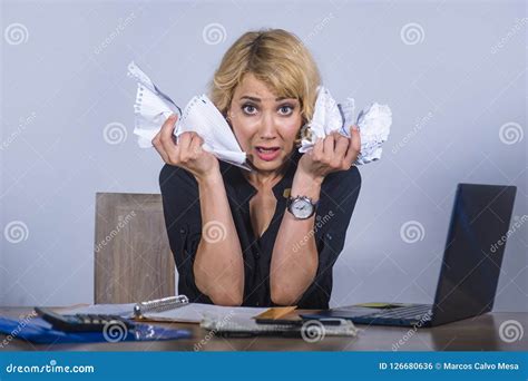 desperate and stressed business woman working overwhelmed at office desk with laptop computer