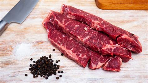 Uncooked Beef Marbled Steak Served With Pepper On The Table Stock Image