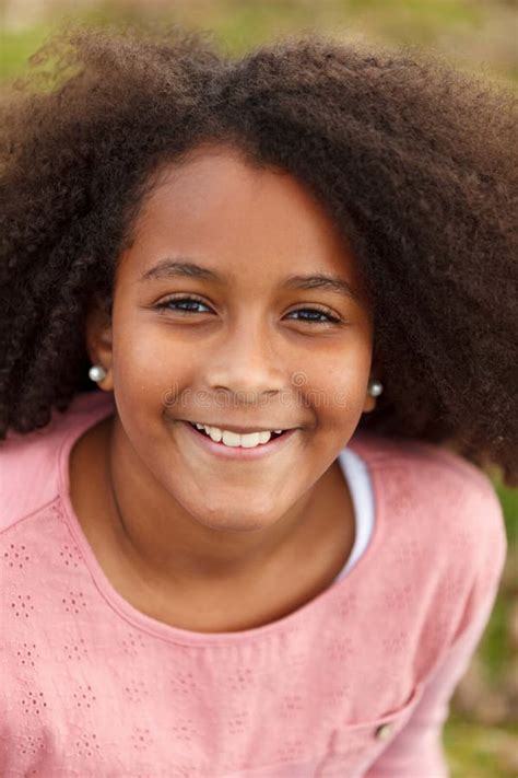 Cute African American Girl In The Street With Afro Hair Stock Photo