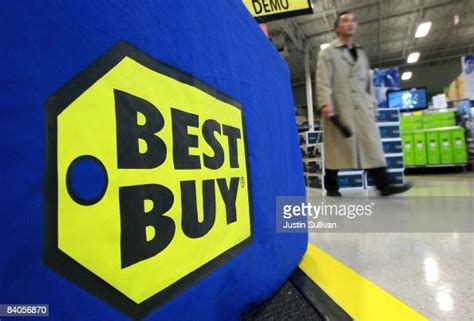 A Best Buy Customer Walks By A Sign At A Best Buy Store December 16