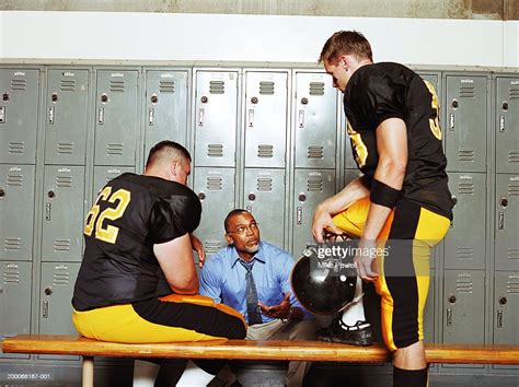 Football Players Listening To Coach In Locker Room Photo Getty Images