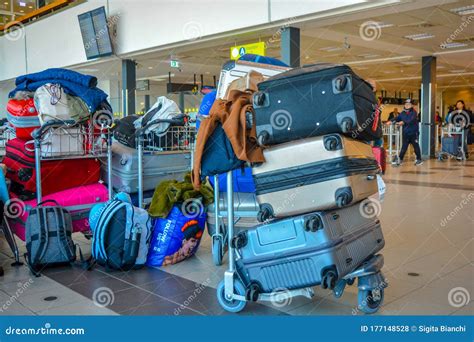 A Typical Travel Scene Luggage Cart Full Of Baggages And Bags In The