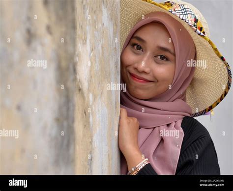 Young Woman Portrait With Eyes Closed And Sun Hat Hi Res Stock