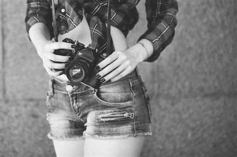 Premium Photo Girl In Shorts And A Red Shirt With A Retro Camera In Her Hands