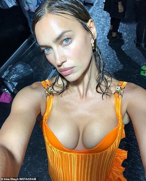 Irina Shayk Puts On A Busty Display For Selfie In Plunging Orange Gown