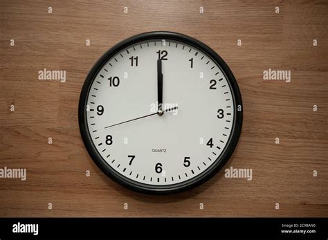 Wall Clock Indicating The Twelve Oclock Hour Stock Photo Alamy