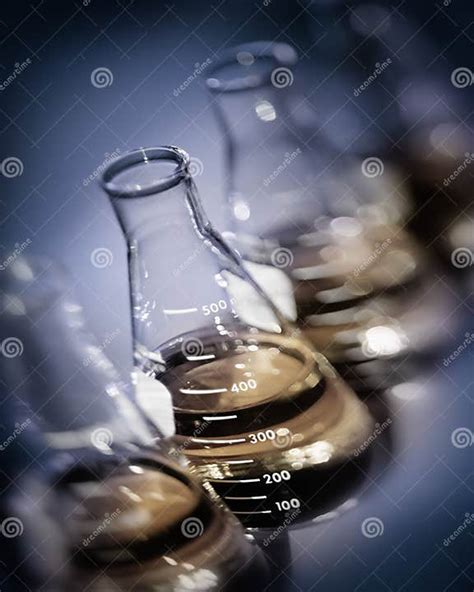Selective Focus Laboratory Flasks With Yellow Gold Solutions Stock