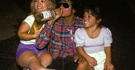 oh well just a normal pic of michael jackson sitting on a car sipping vodka with two midgets