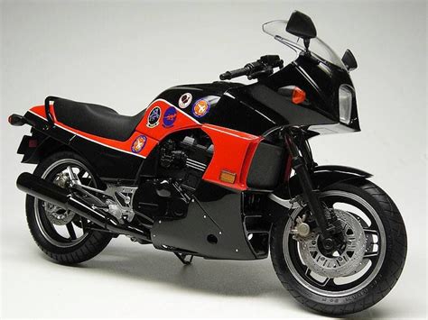 A Red And Black Toy Motorcycle On A White Background