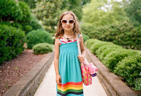 Cute Young Girl Standing Outside Waiting To Go To The Beach By Stocksy Contributor Jakob