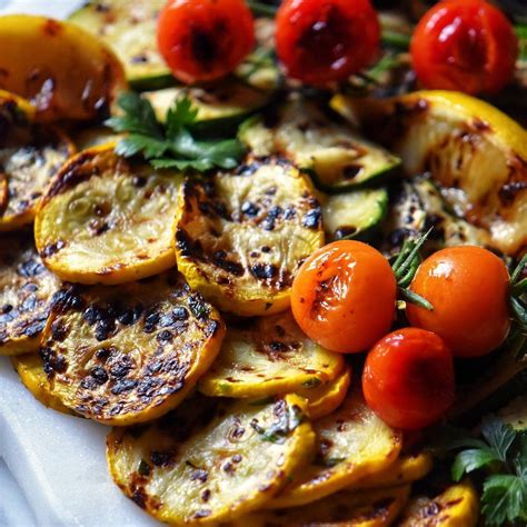 Grilled Vegetables With Herbs And Tomatoes On A White Platter Ready To