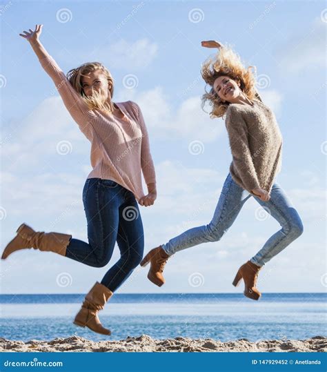 Two Women Jumping Stock Photo Image Of Friendship Friends 147929452
