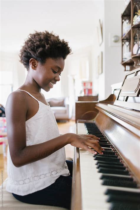 African American Girl At Piano By Stocksy Contributor Raymond Forbes