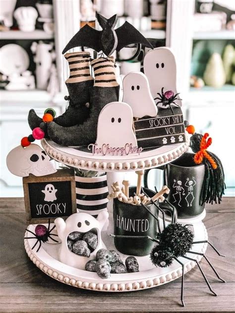 Halloween Decorations On A Table In A Room With White Walls And Black