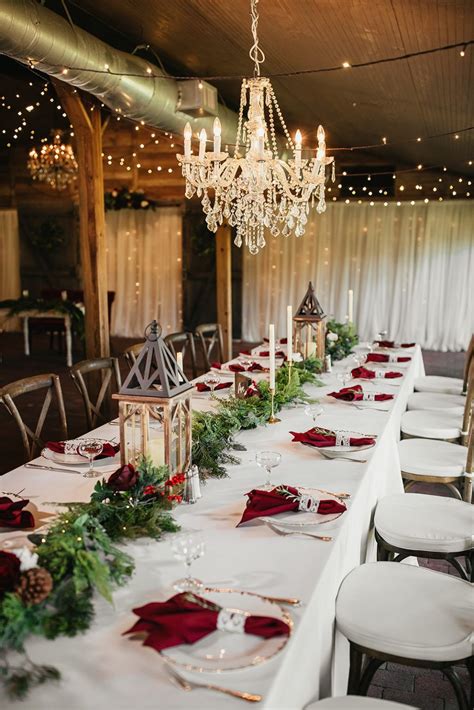 a long table with white chairs and red napkins