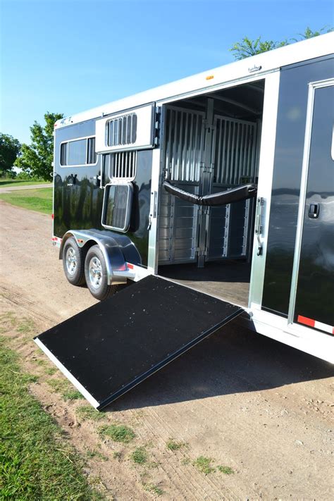 An Enclosed Trailer Is Parked On The Side Of A Dirt Road With Its Door Open