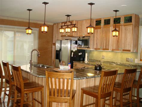 Most kitchen designers recommend that you pick your granite counters before the cabinets. Natural Hickory cabinets with solid granite counter top ...