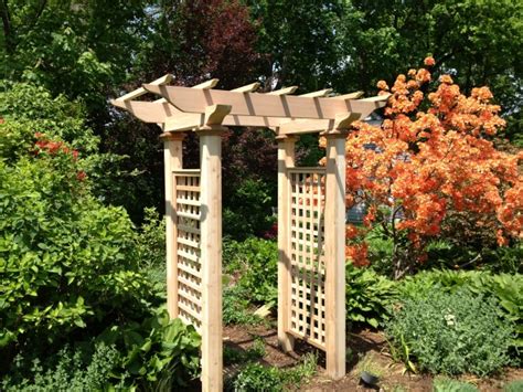 The wooden arbor has since been painted. Wooden Cedar Garden Arbor by New England Woodworks