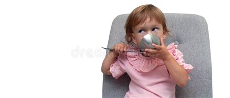 Cute Small Kid Girl Eats From Big Spoon Hungry Funny Baby Stock Image